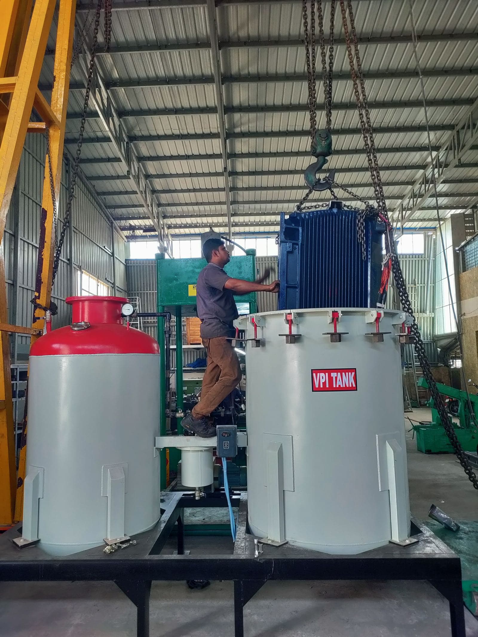 A machine being lowered into the VPI tank