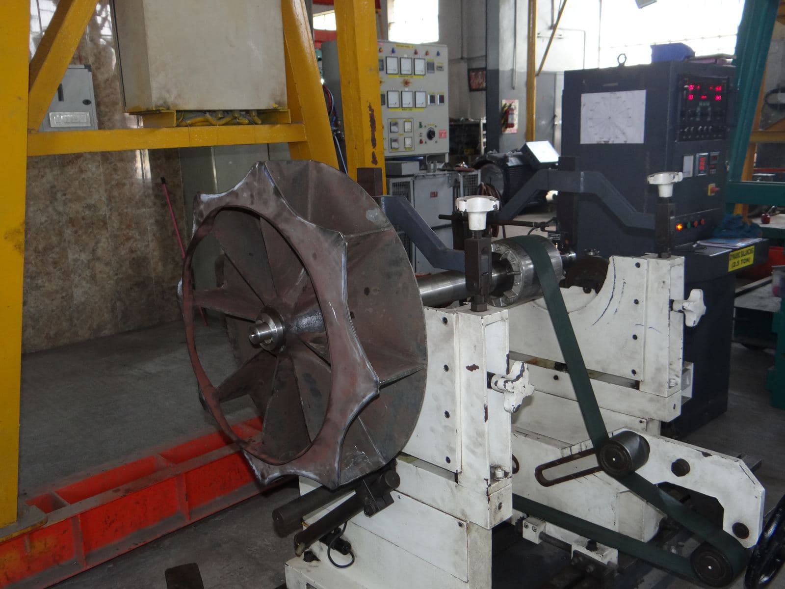 A special application induction motor rotor being balanced with its blower fan