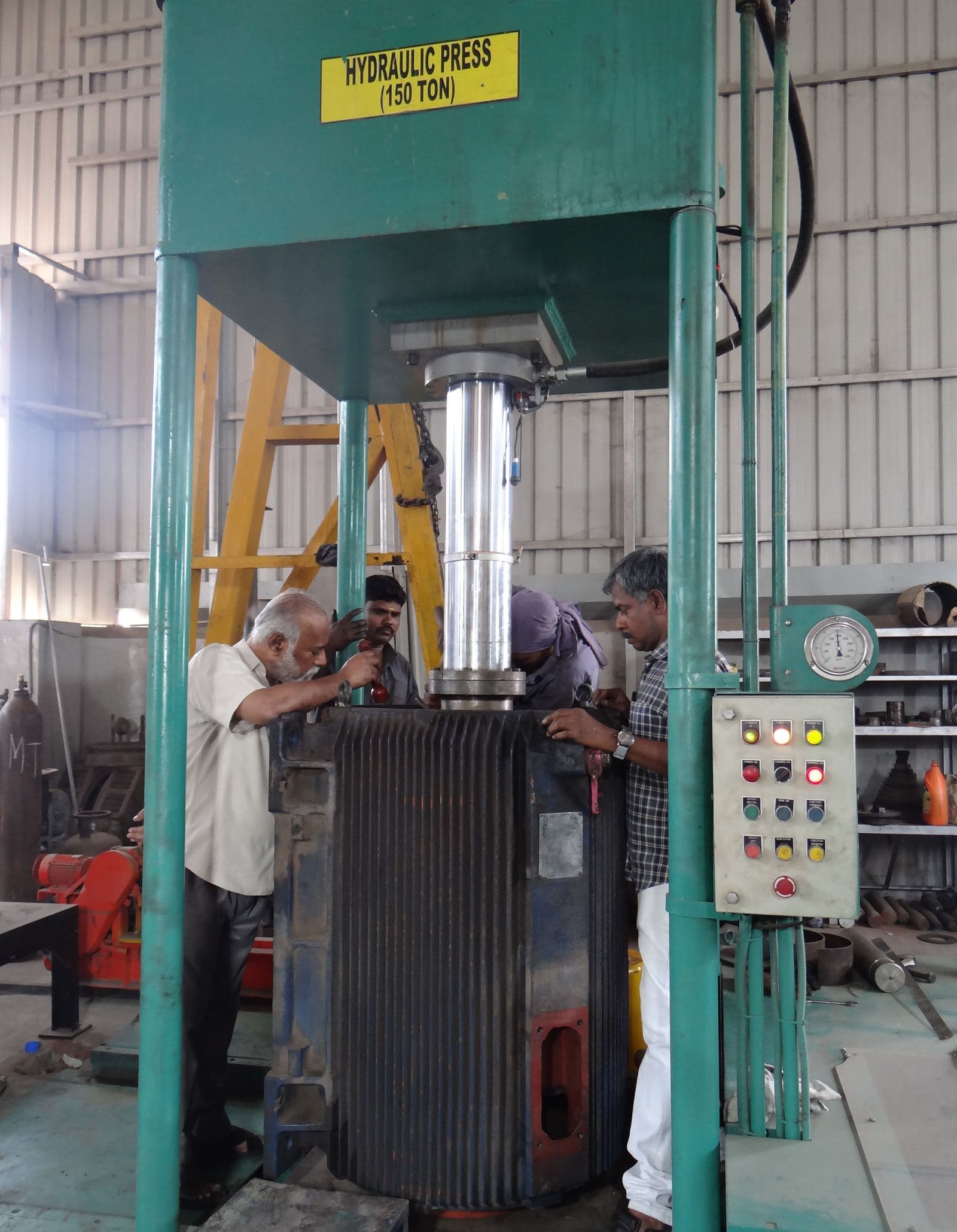 Members of our team pressing out the stator stack from the motor body